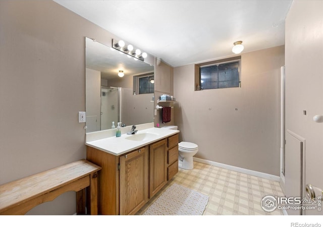 bathroom featuring vanity, toilet, and walk in shower