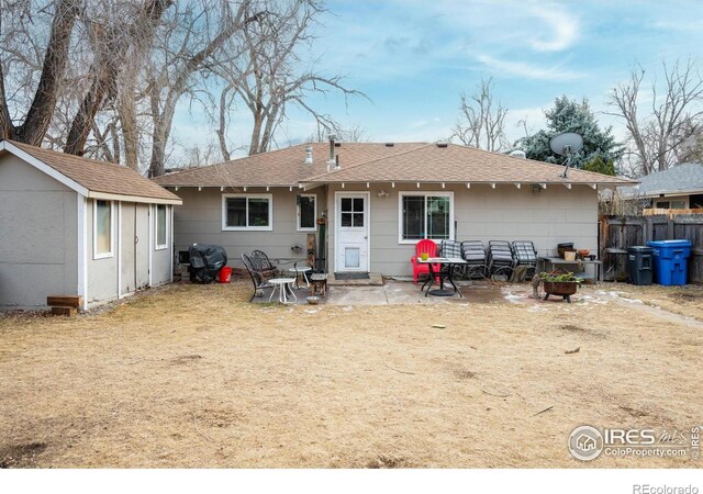 back of property with a shed