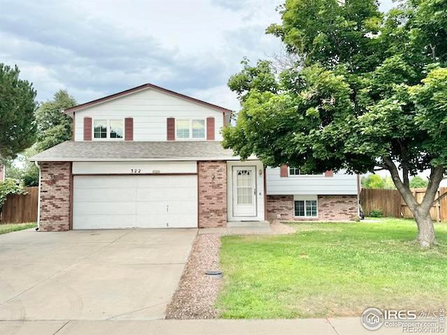 tri-level home with a garage and a front yard