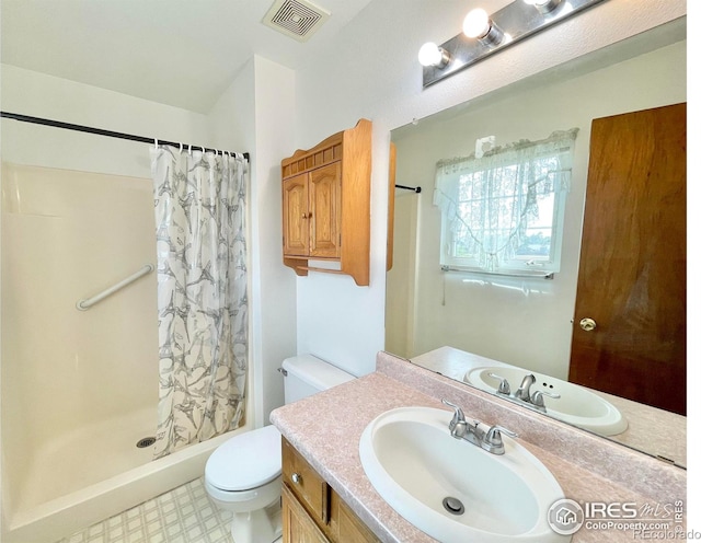 bathroom featuring vanity, curtained shower, and toilet