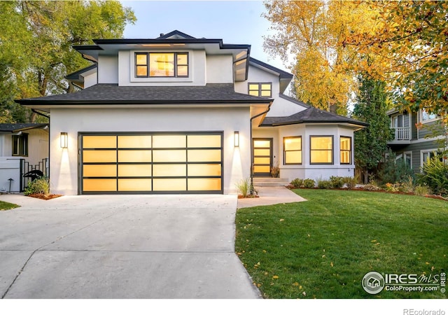 view of front of property featuring a garage and a front yard