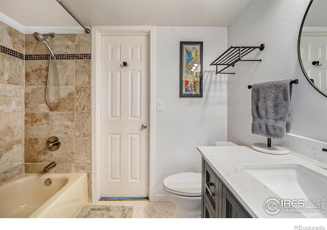 full bathroom with tiled shower / bath, vanity, and toilet