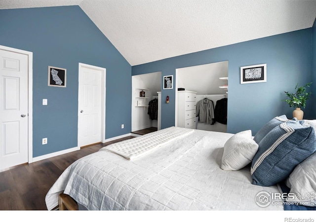 bedroom featuring lofted ceiling, dark hardwood / wood-style floors, and a textured ceiling