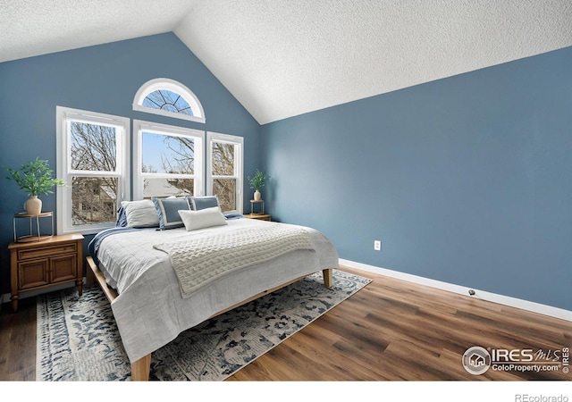 bedroom featuring hardwood / wood-style flooring, high vaulted ceiling, and a textured ceiling