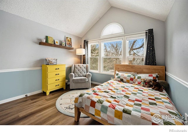 bedroom with dark hardwood / wood-style flooring, lofted ceiling, and a textured ceiling