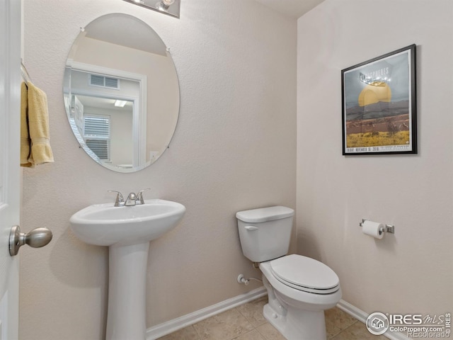 bathroom featuring tile patterned flooring, sink, and toilet