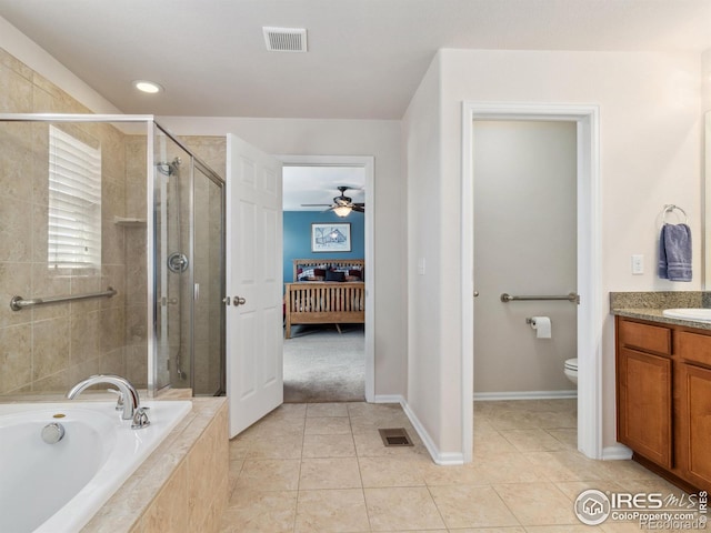 full bathroom with independent shower and bath, tile patterned flooring, vanity, ceiling fan, and toilet