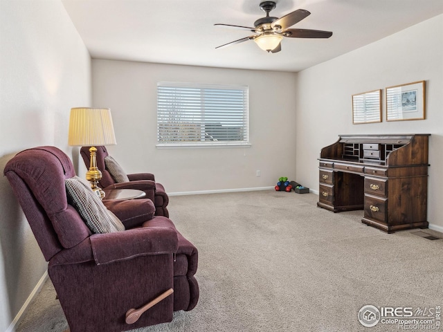 living area featuring light colored carpet and ceiling fan