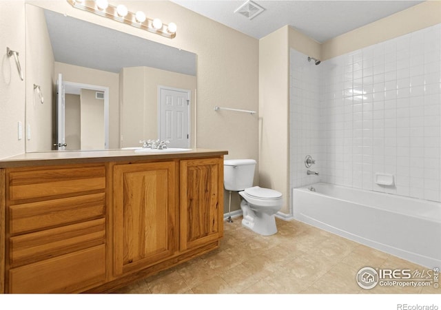 full bathroom with vanity, toilet, and tiled shower / bath combo