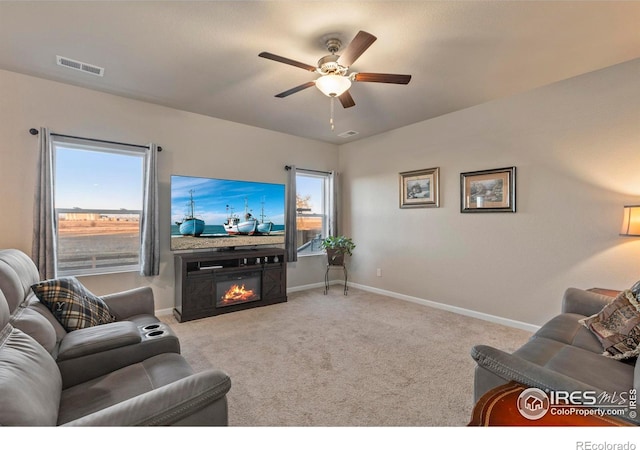 living room with light colored carpet and ceiling fan