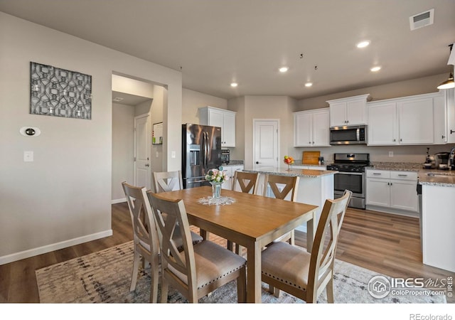 dining area featuring dark hardwood / wood-style flooring and sink