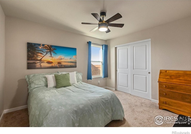 carpeted bedroom with a closet and ceiling fan