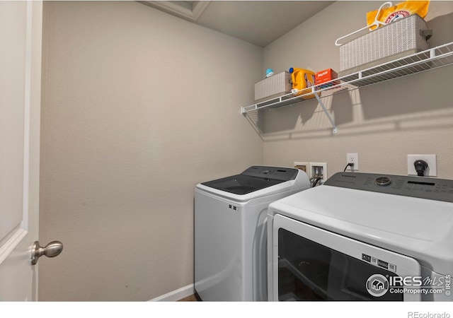 clothes washing area featuring washing machine and clothes dryer