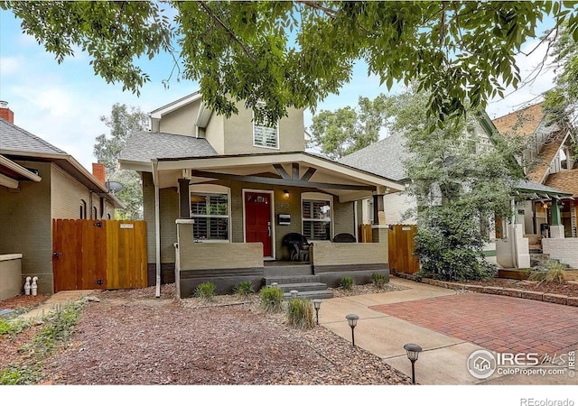 view of front of property with covered porch and a patio area