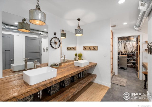 bathroom with sink and concrete floors