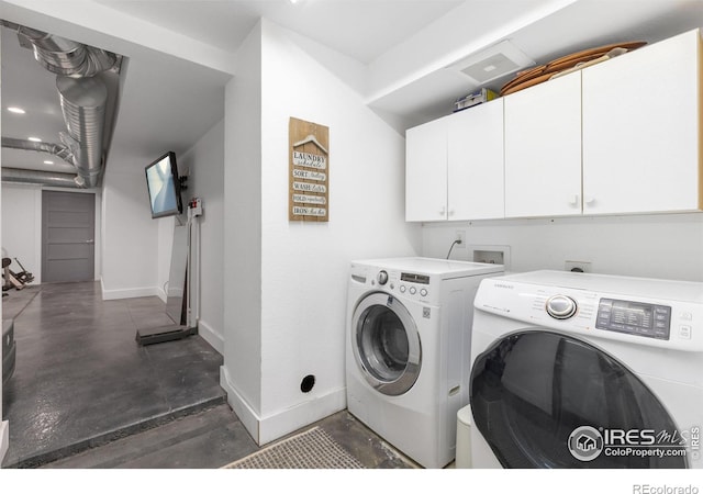 laundry area with cabinets and washing machine and dryer