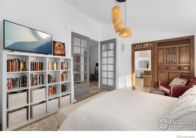 bedroom with lofted ceiling and french doors