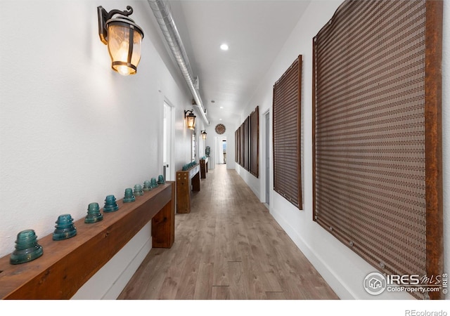 corridor with light hardwood / wood-style floors