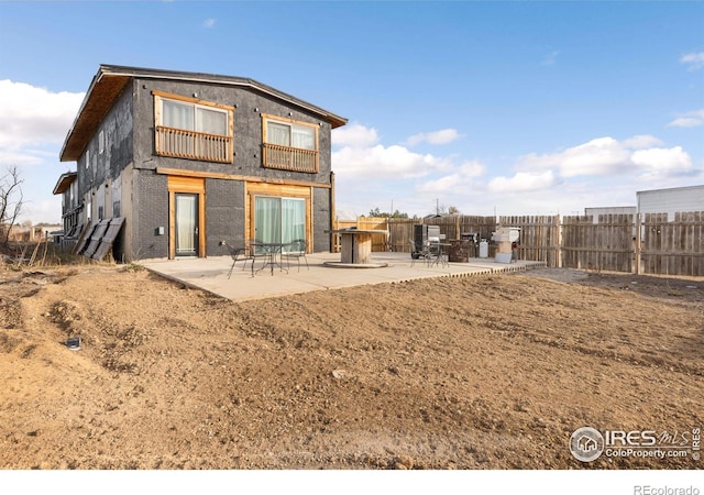 rear view of property featuring a patio area