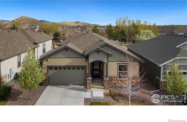 view of front of property featuring a mountain view and a garage