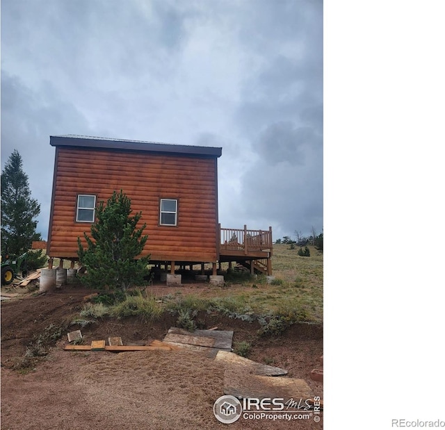 view of side of property featuring a deck