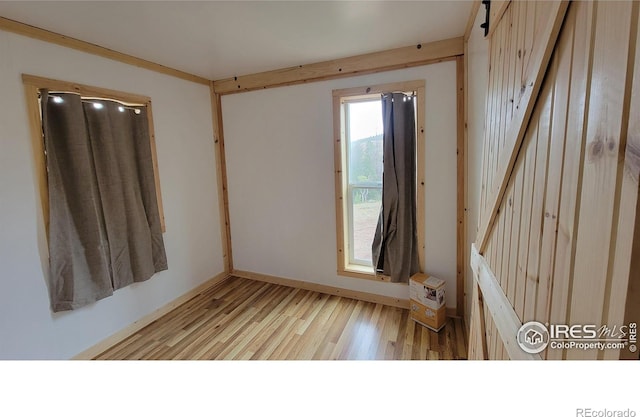 unfurnished room with light wood-type flooring