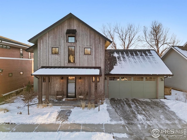 view of front of property featuring a garage and a porch