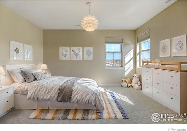 bedroom featuring light colored carpet