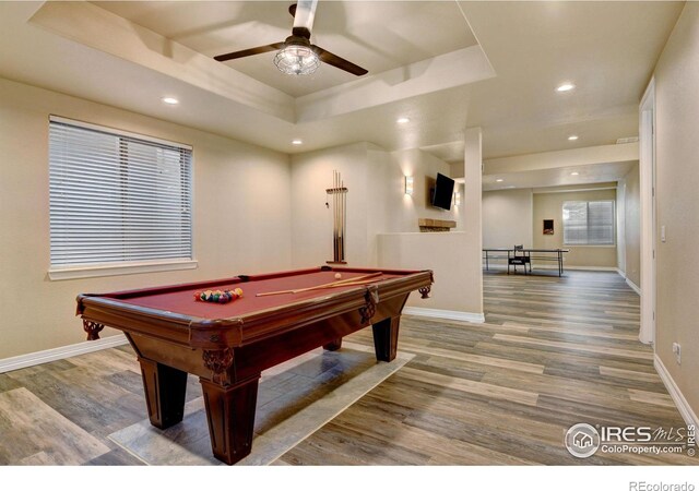 rec room featuring ceiling fan, billiards, a tray ceiling, and hardwood / wood-style floors