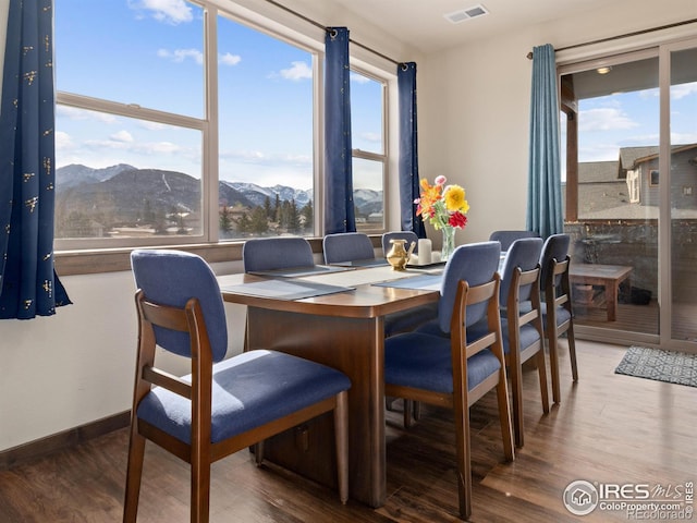 dining area with wood-type flooring and a mountain view