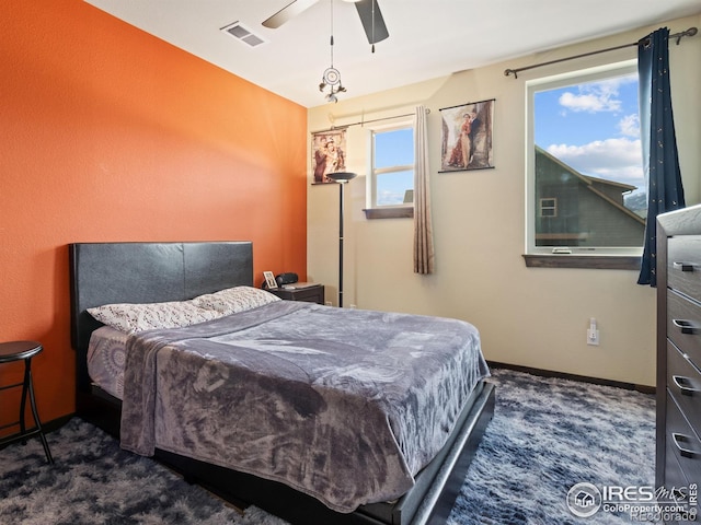 bedroom with dark carpet and ceiling fan