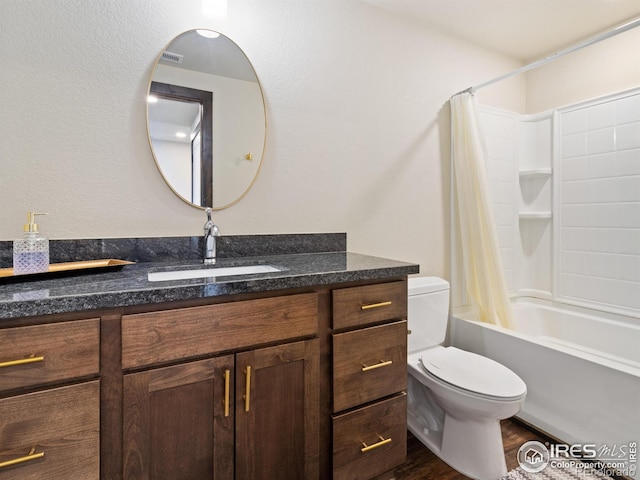 full bathroom with shower / bathtub combination with curtain, vanity, hardwood / wood-style flooring, and toilet