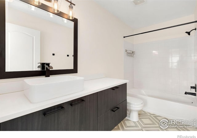 bathroom with toilet, bathing tub / shower combination, vanity, and visible vents