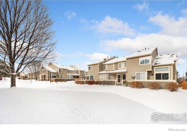 snow covered property featuring a residential view