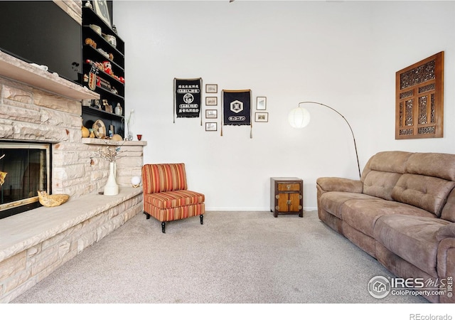 carpeted living room featuring a fireplace