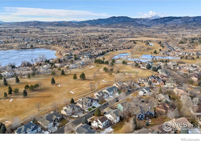 drone / aerial view featuring a water and mountain view