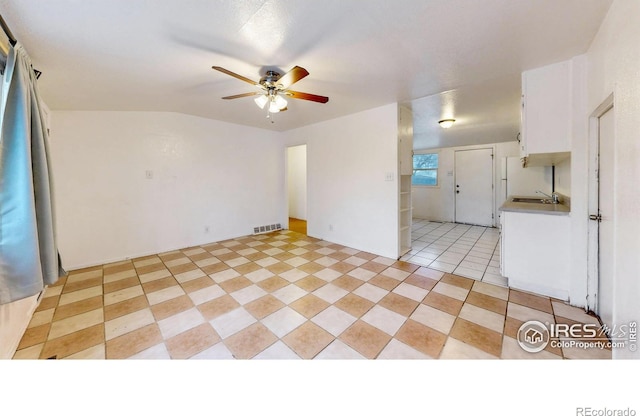 414 16th Avenue Ct, Greeley, CO 80631 - spare room with ceiling fan, light tile patterned flooring, and vaulted ceiling