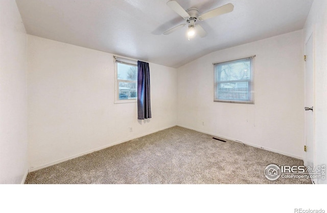414 16th Avenue Ct, Greeley, CO 80631 - carpeted empty room featuring healthy amount of natural light, vaulted ceiling, and a ceiling fan