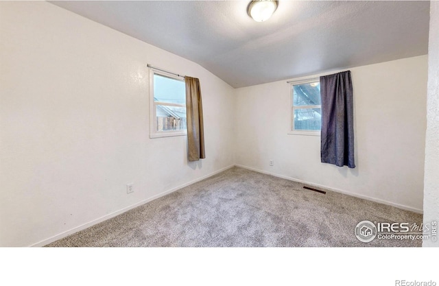 414 16th Avenue Ct, Greeley, CO 80631 - carpeted spare room with vaulted ceiling and healthy amount of natural light