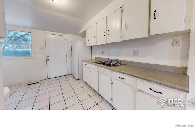 414 16th Avenue Ct, Greeley, CO 80631 - kitchen with freestanding refrigerator, white cabinetry, light countertops, light tile patterned flooring, and lofted ceiling