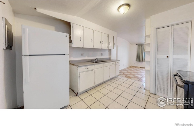 414 16th Avenue Ct, Greeley, CO 80631 - kitchen featuring freestanding refrigerator, light countertops, white cabinetry, lofted ceiling, and dishwasher
