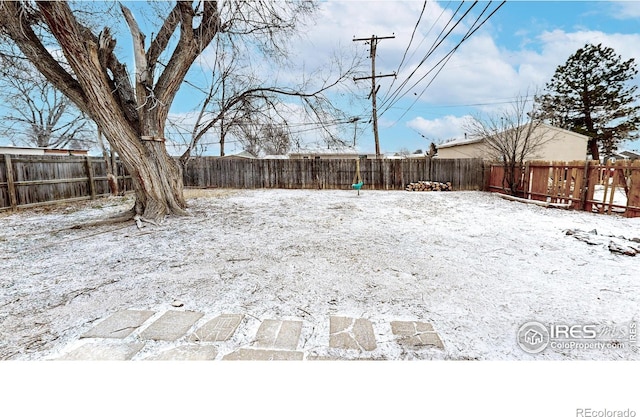 414 16th Avenue Ct, Greeley, CO 80631 - yard layered in snow with a fenced backyard