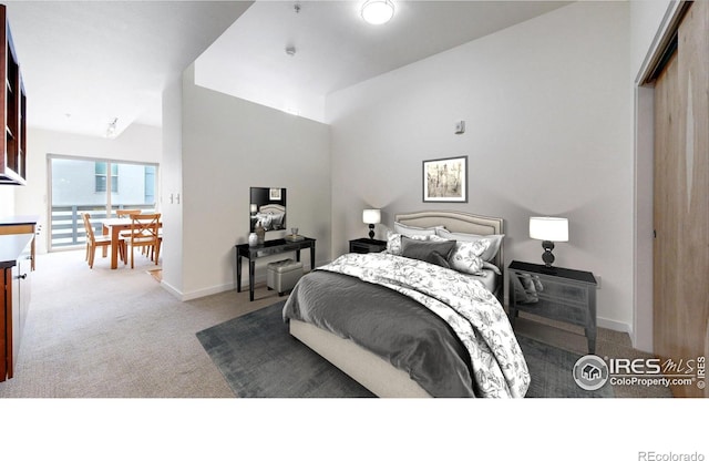 carpeted bedroom featuring lofted ceiling