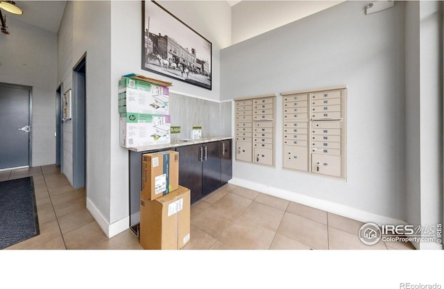 interior space featuring light tile patterned floors and a mail area