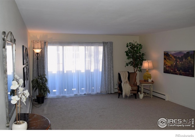 interior space with carpet and a baseboard heating unit