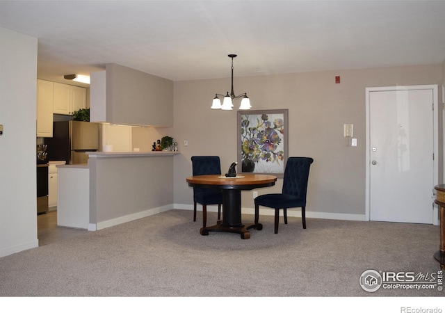 dining area with light colored carpet and a chandelier