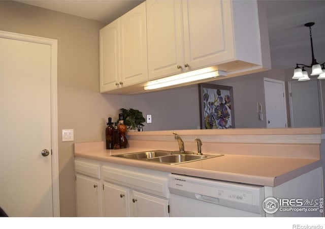 kitchen with sink, an inviting chandelier, white dishwasher, pendant lighting, and white cabinets