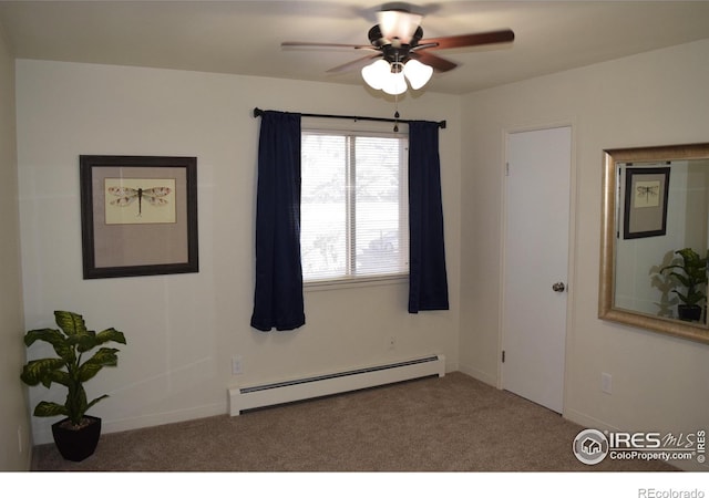 carpeted spare room featuring a baseboard radiator and ceiling fan