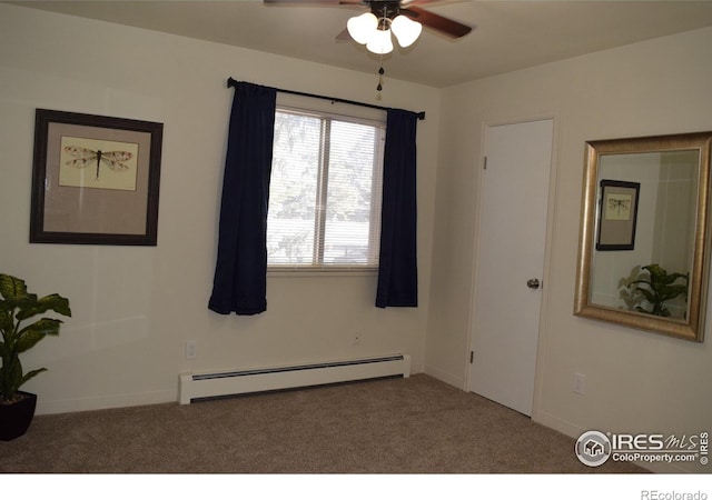 spare room with a baseboard radiator, carpet, and ceiling fan