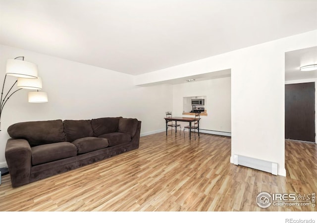 living room featuring hardwood / wood-style flooring and baseboard heating